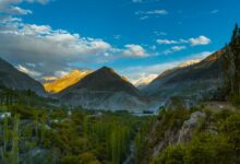 Sweeping view of a high-altitude valley surrounded by snow-capped Karakoram peaks in northern Pakistan