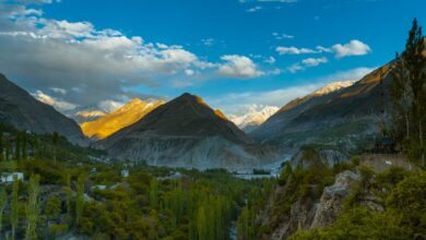 Sweeping view of a high-altitude valley surrounded by snow-capped Karakoram peaks in northern Pakistan