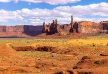 A remote high-altitude desert valley with dry mountains and a winding river below