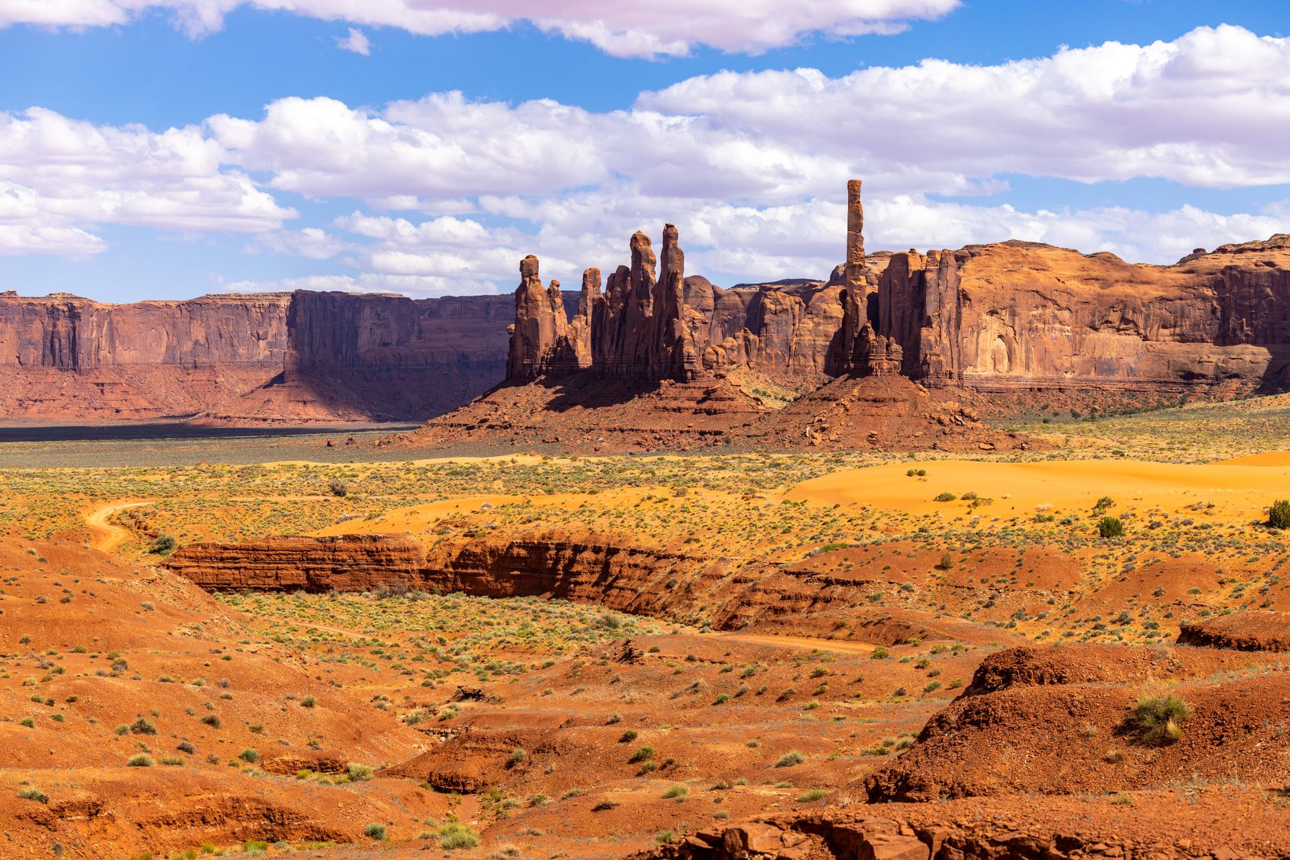 A remote high-altitude desert valley with dry mountains and a winding river below