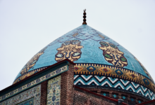 Intricate blue and turquoise tilework on the exterior of a Persian mosque in Isfahan, Iran