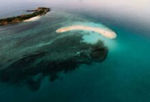 Aerial view of a remote tropical archipelago with turquoise water and coral reefs