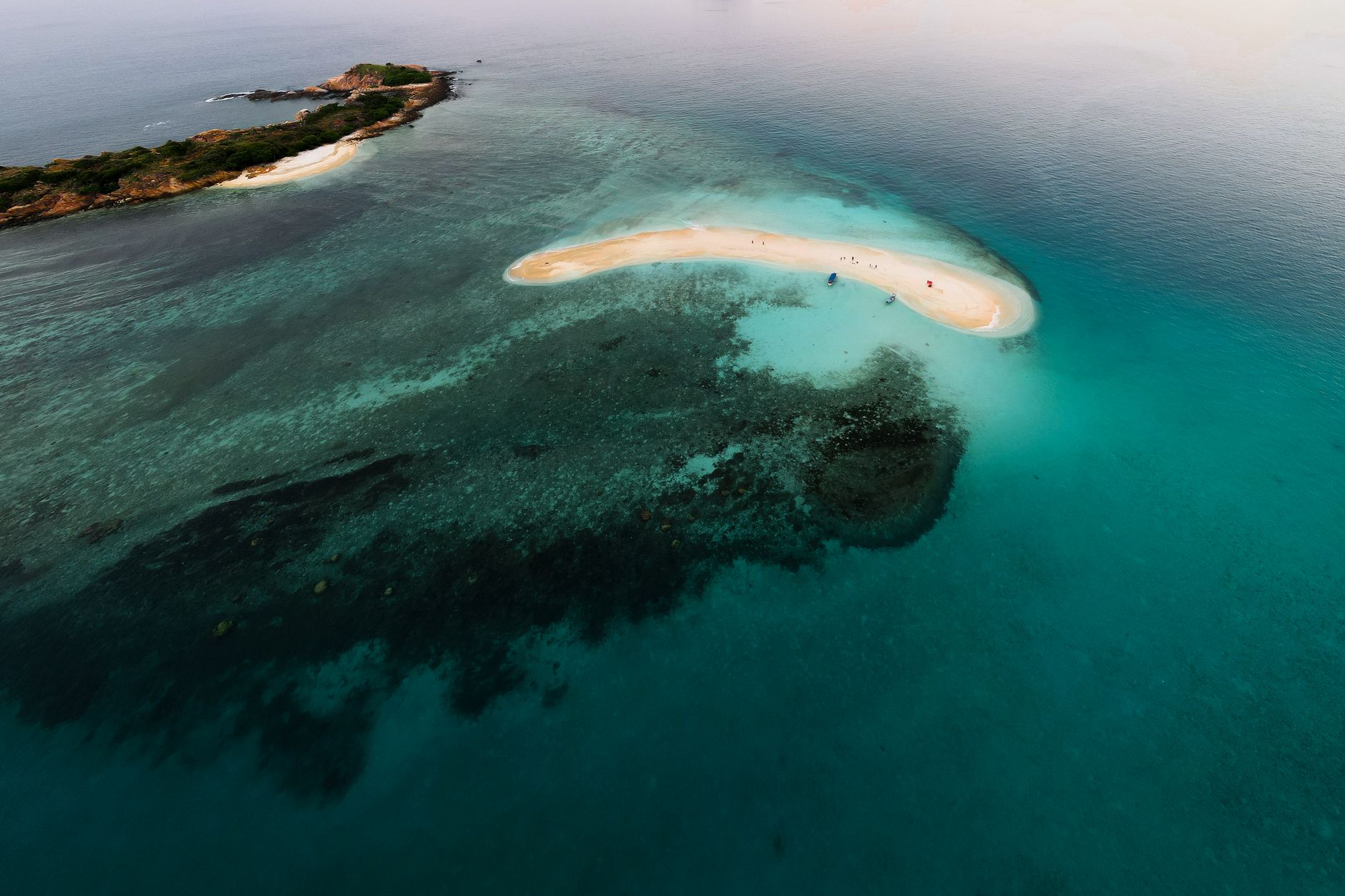 Aerial view of a remote tropical archipelago with turquoise water and coral reefs
