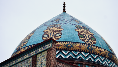 Intricate blue and turquoise tilework on the exterior of a Persian mosque in Isfahan, Iran