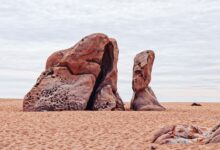 Towering sandstone rock formations rising from the red desert floor in Wadi Rum, Jordan