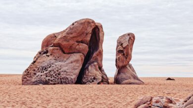 Towering sandstone rock formations rising from the red desert floor in Wadi Rum, Jordan