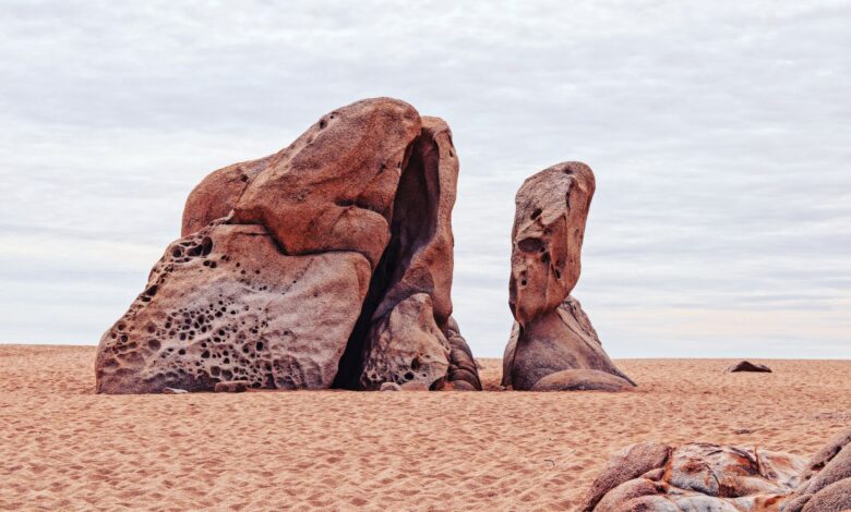 Towering sandstone rock formations rising from the red desert floor in Wadi Rum, Jordan