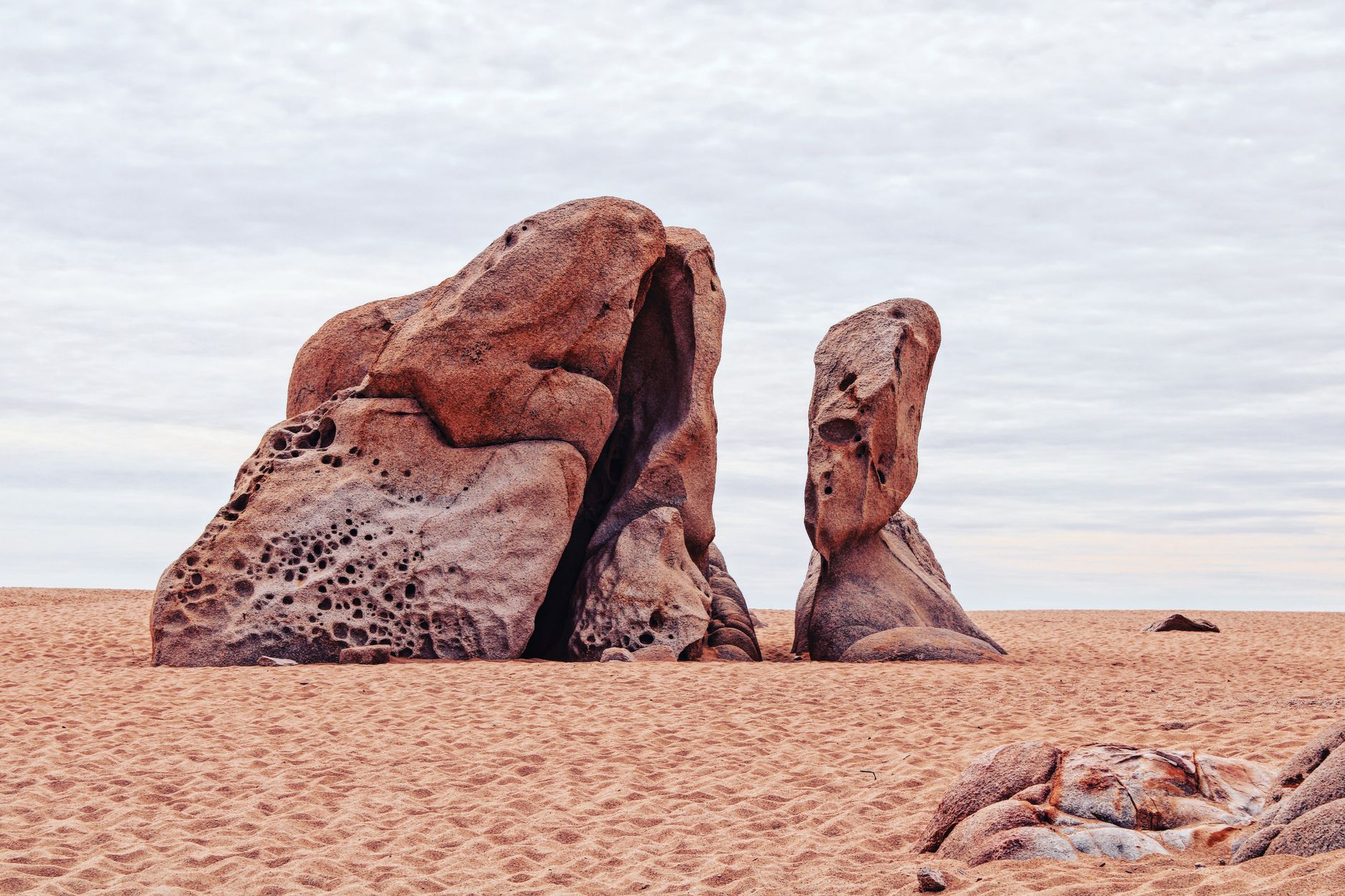 Towering sandstone rock formations rising from the red desert floor in Wadi Rum, Jordan