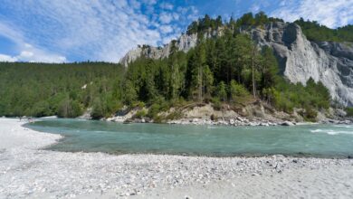 Crystal-clear turquoise river flowing through a forested alpine valley in Slovenia