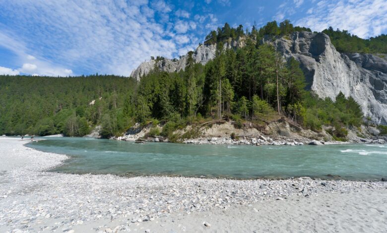 Crystal-clear turquoise river flowing through a forested alpine valley in Slovenia