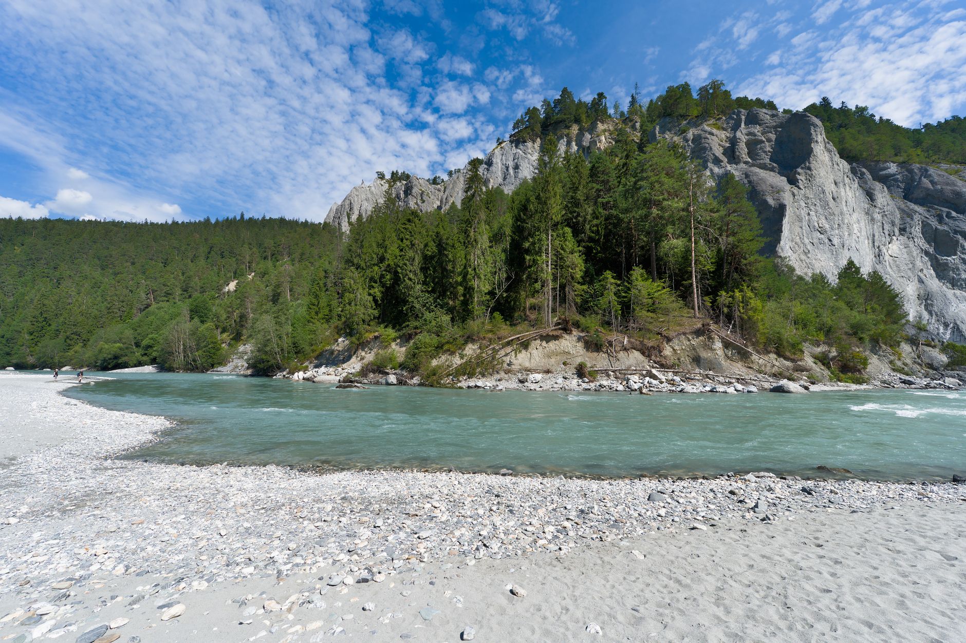 Crystal-clear turquoise river flowing through a forested alpine valley in Slovenia