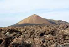 Colorful hydrothermal pools and sulfur formations in a volcanic depression landscape