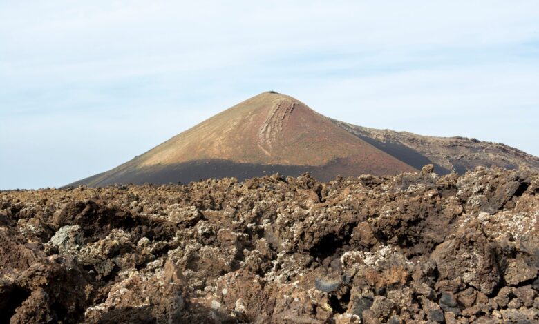 Colorful hydrothermal pools and sulfur formations in a volcanic depression landscape