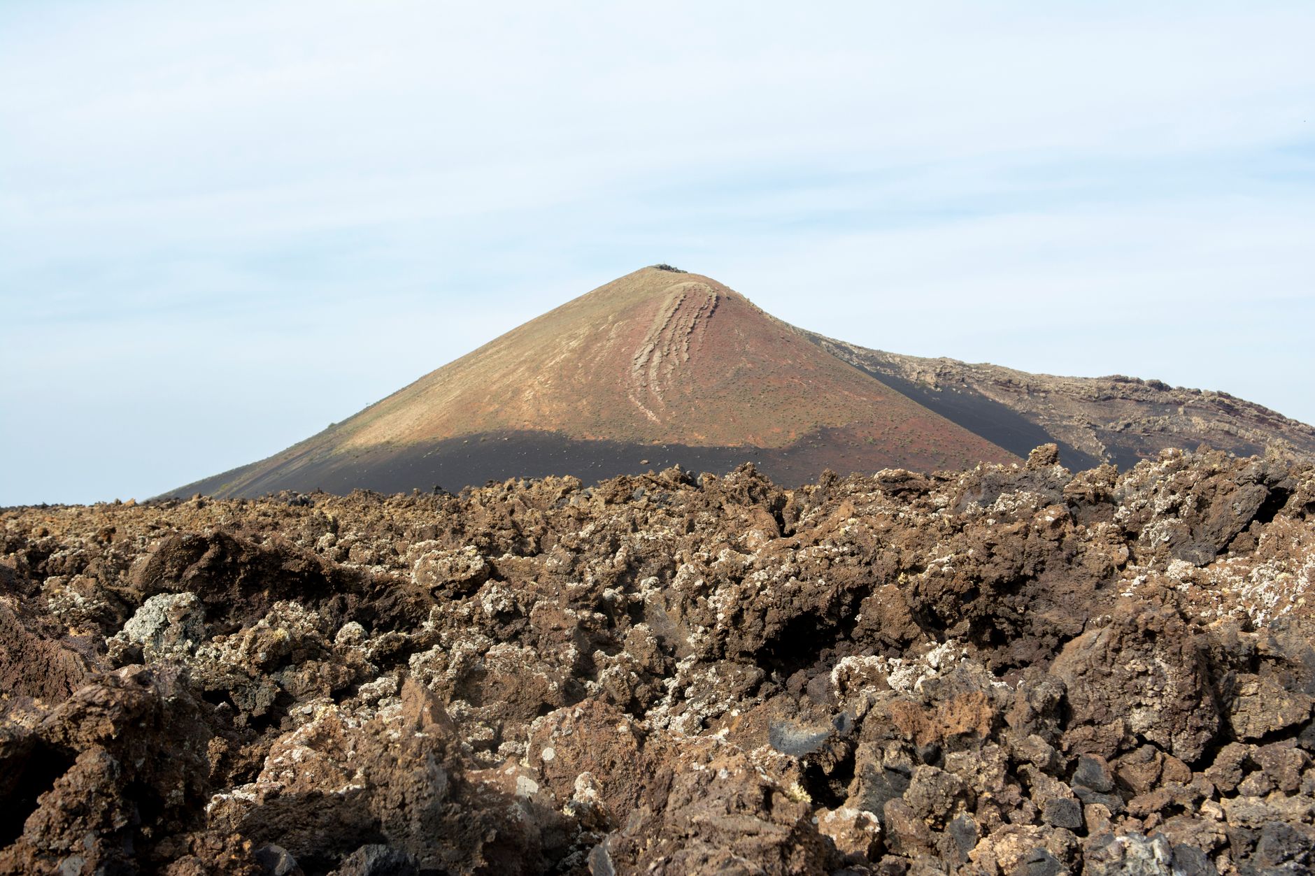 Colorful hydrothermal pools and sulfur formations in a volcanic depression landscape