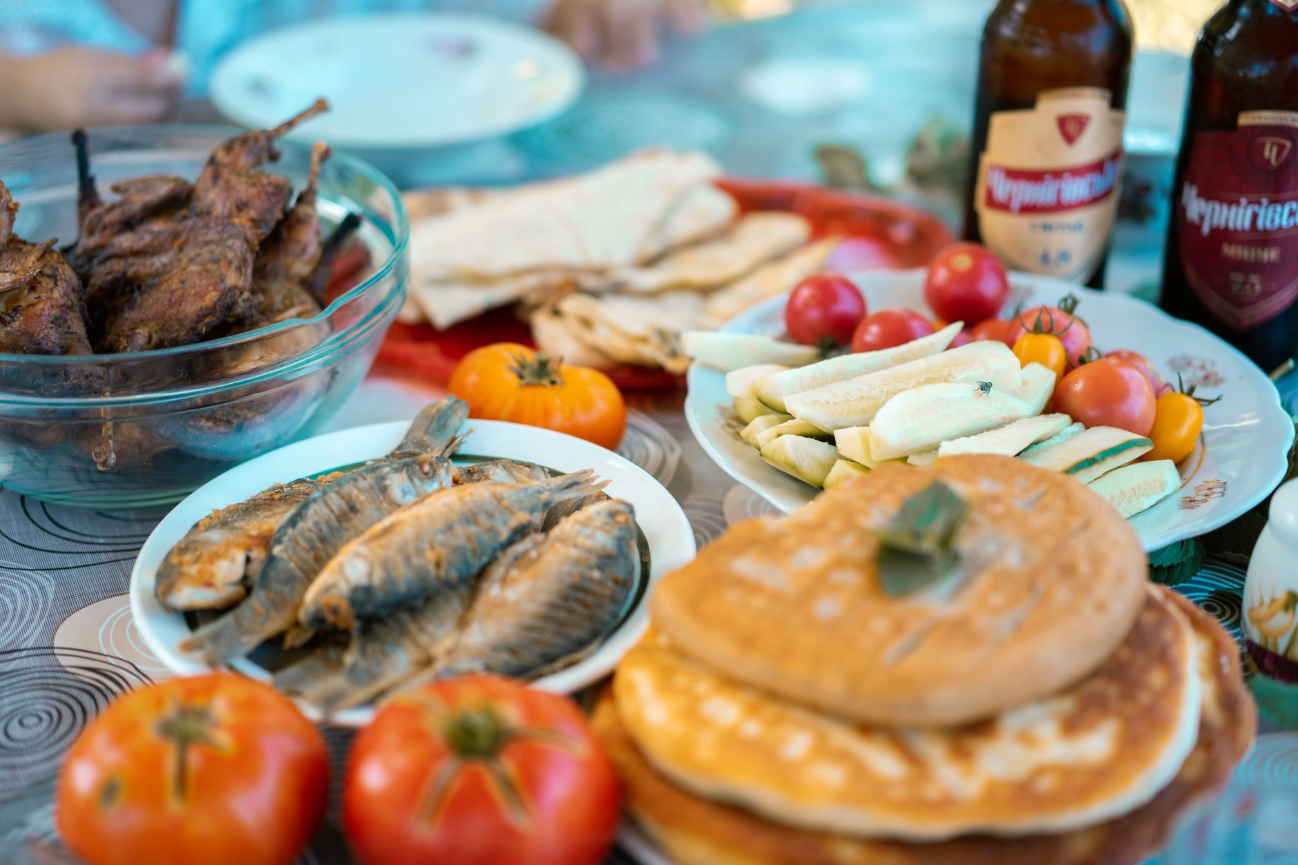 Rustic wooden table set with traditional Balkan cured meats, bread, and dairy spreads