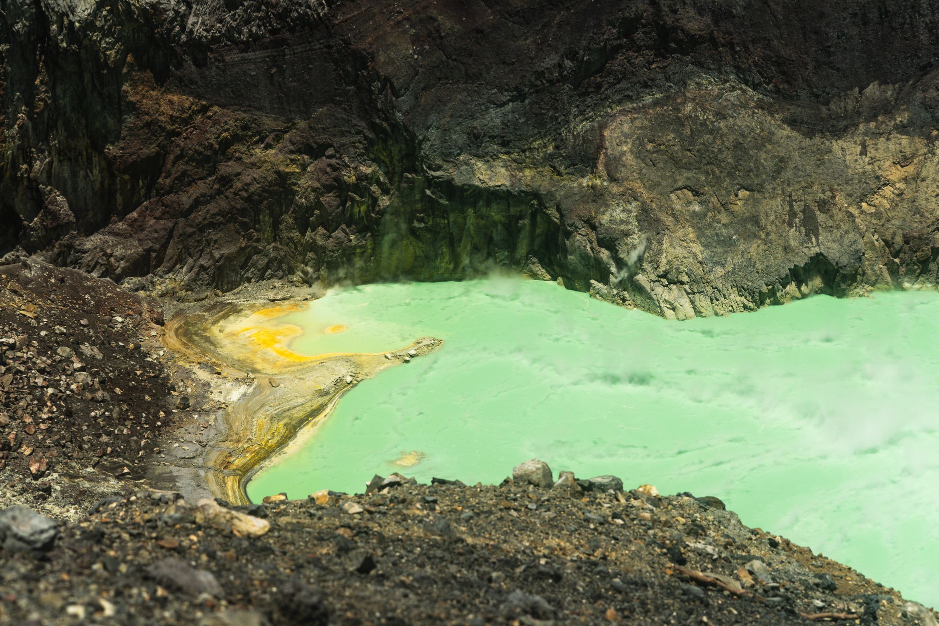 Active lava lake glowing orange at night inside a volcanic crater