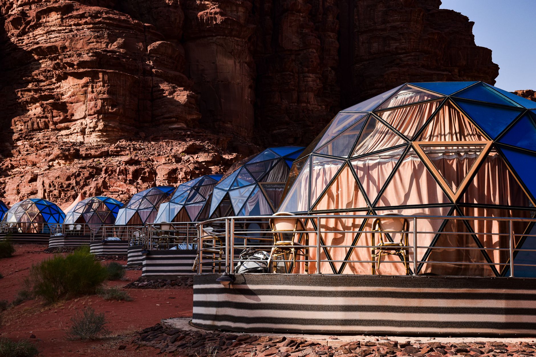 A remote desert campsite set within a sandstone canyon under a starlit night sky