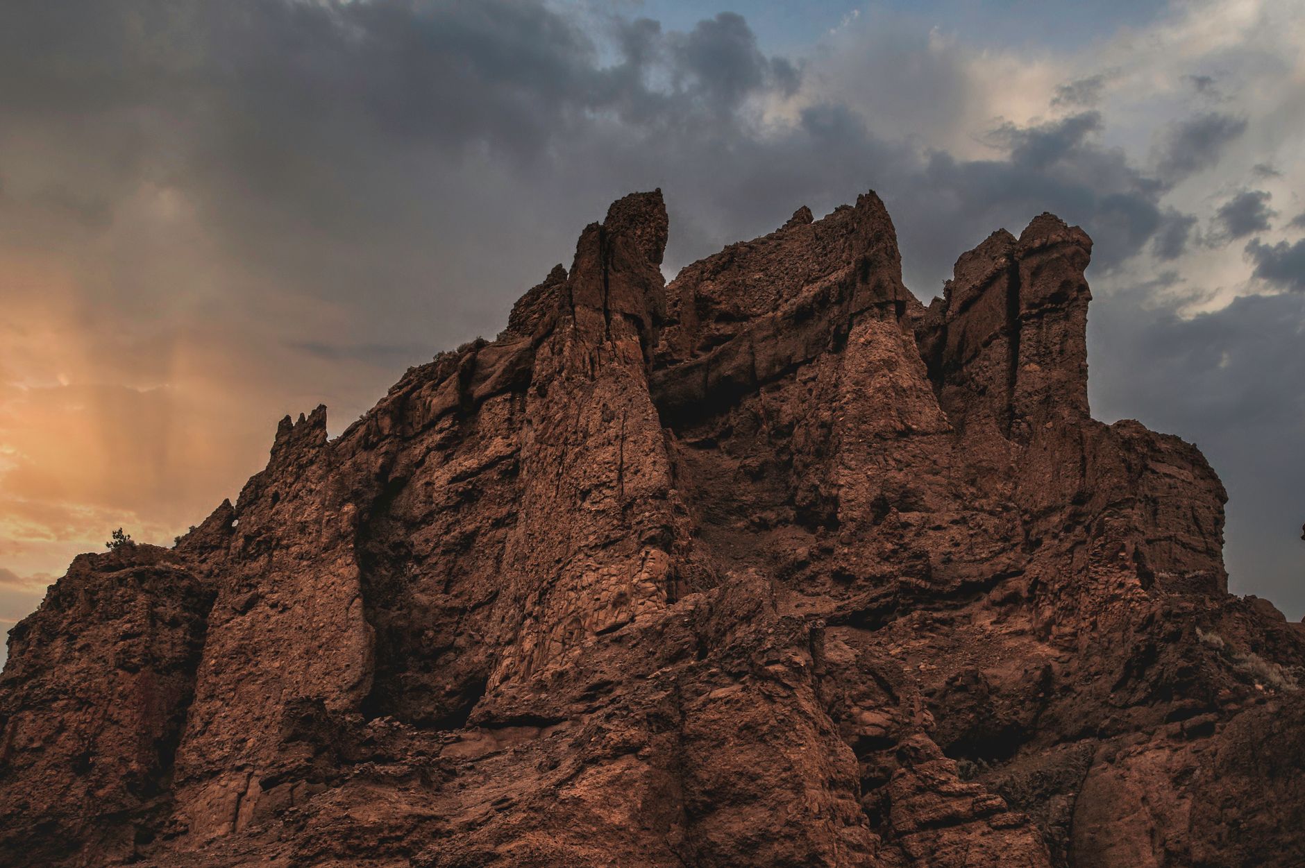 Pale rock formations lit in warm amber light during desert sunset