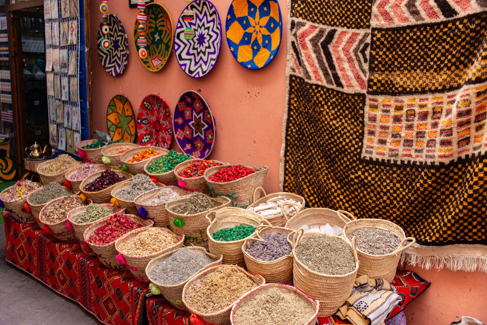 Colorful craft stalls and handwoven textiles in a traditional North African market