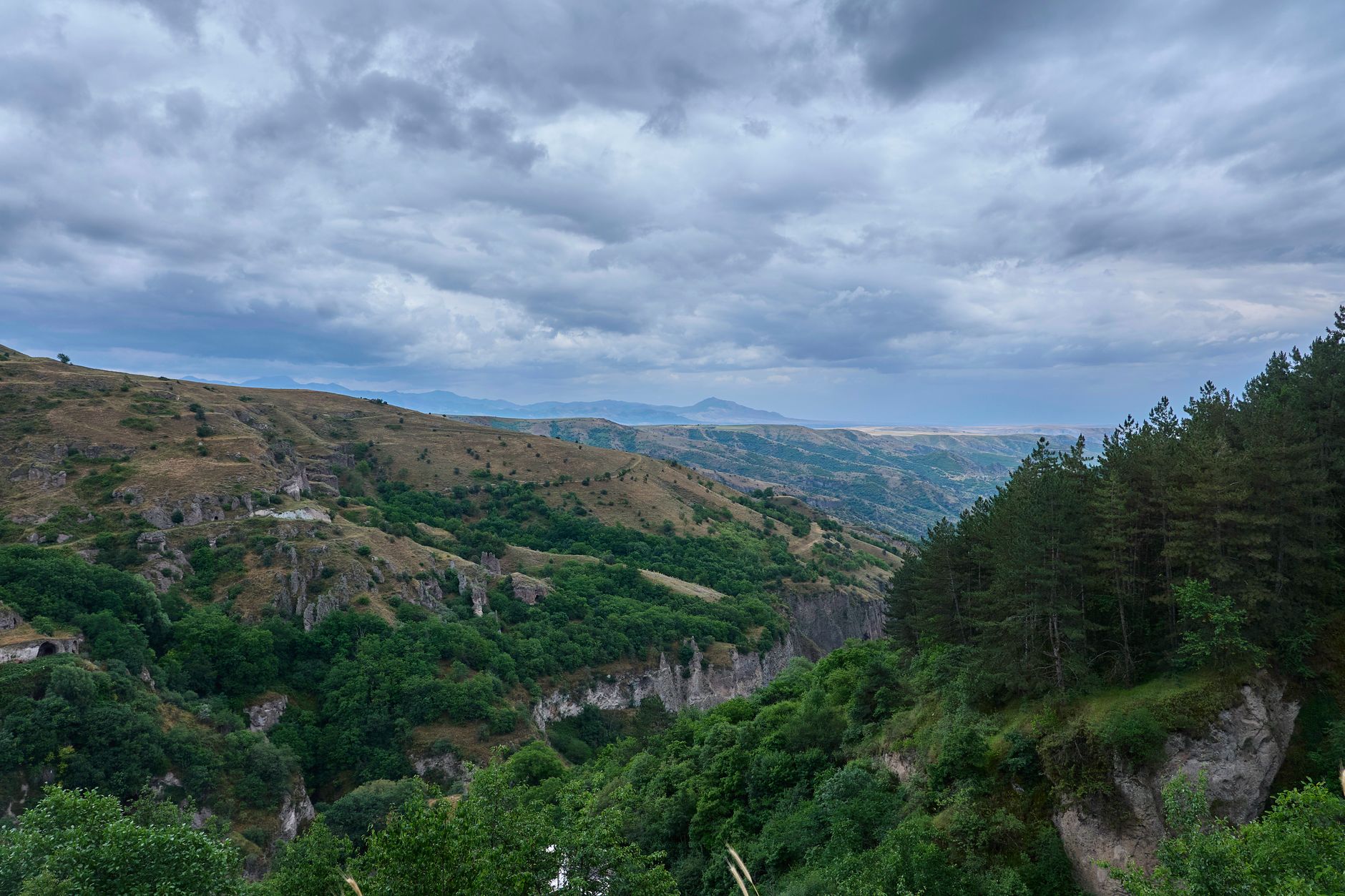 Ancient Armenian monastery surrounded by dense green forest in northern Armenia