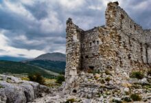 Ancient stone fortress ruins perched on a rocky mountain ridge in northern Iran