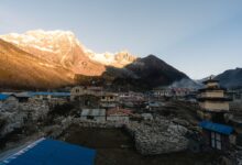 Traditional mud-brick village buildings in Nepal's high-altitude Mustang district under a clear blue sky