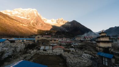 Traditional mud-brick village buildings in Nepal's high-altitude Mustang district under a clear blue sky
