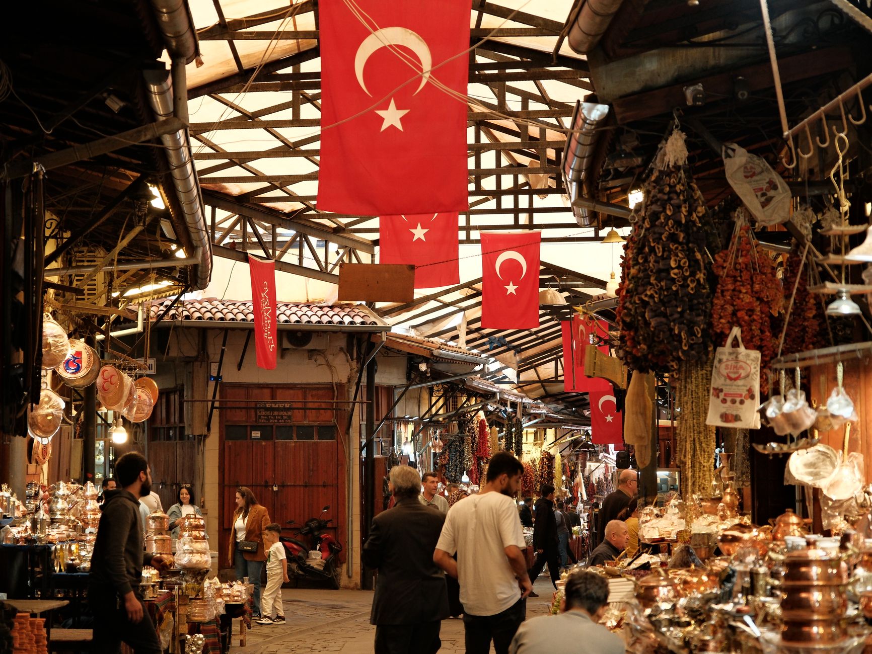 Colorful open-air market stalls along a river in a Central Asian city