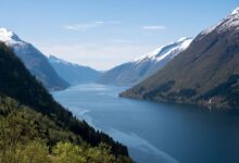 Narrow tropical fjord inlet surrounded by dense jungle in Papua New Guinea