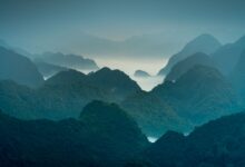Lush green mountain landscape covered in monsoon mist in southern Oman