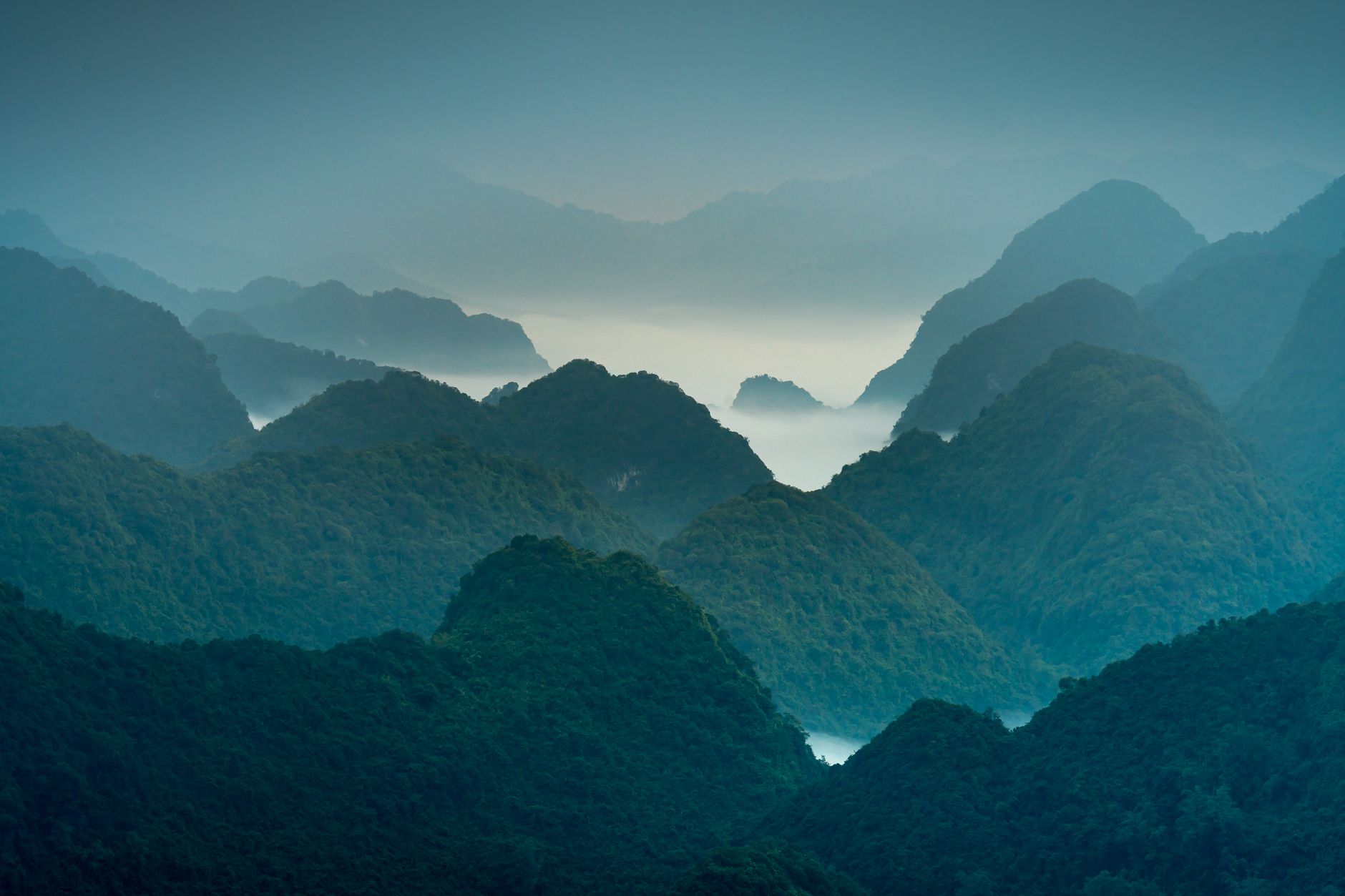 Lush green mountain landscape covered in monsoon mist in southern Oman