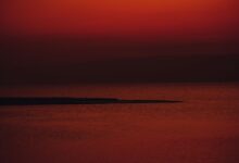 Calm Red Sea coastline with turquoise water and rocky limestone shore