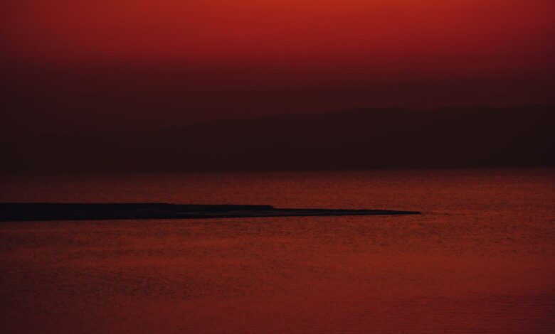 Calm Red Sea coastline with turquoise water and rocky limestone shore