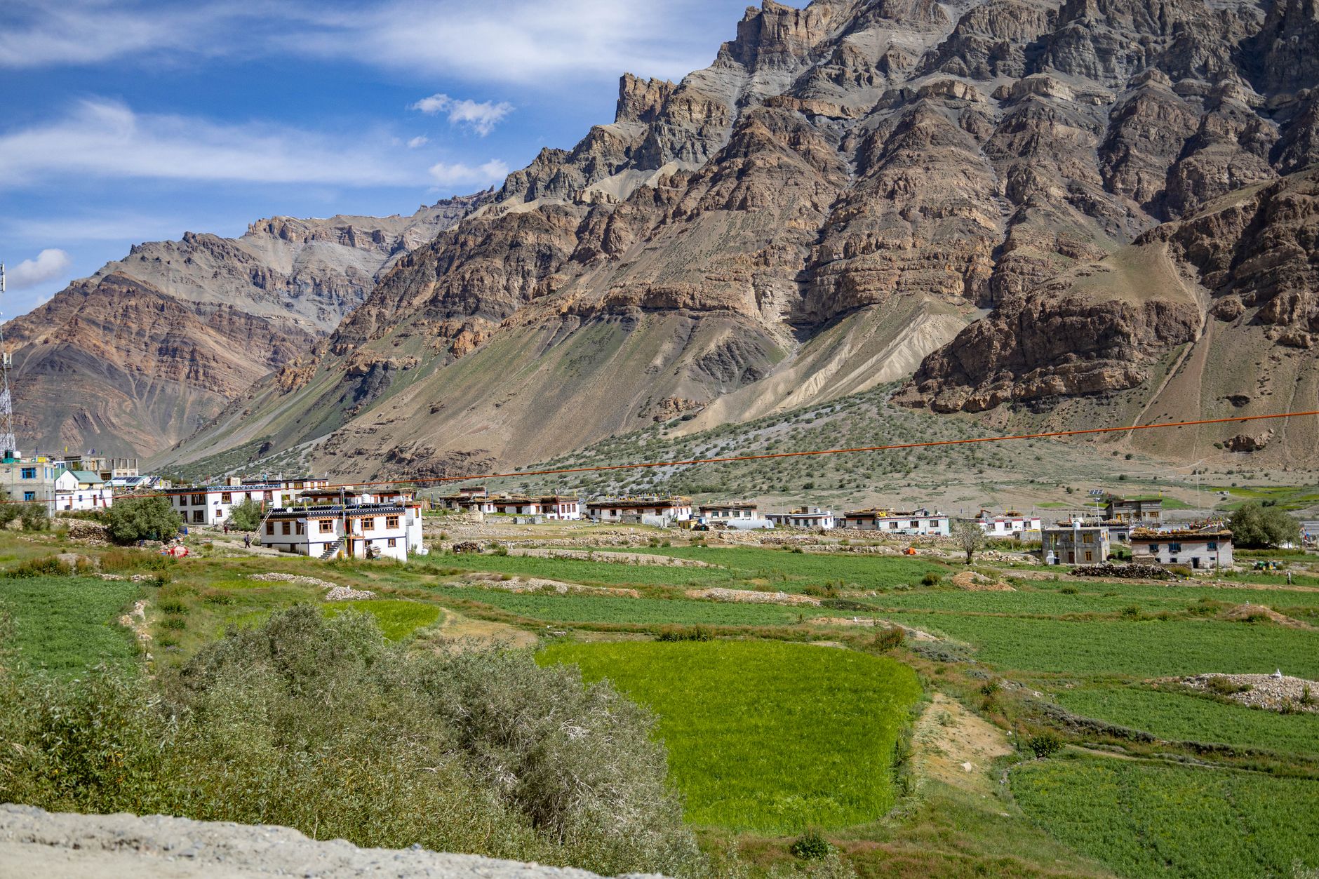 Traditional timber village on a high-altitude plateau surrounded by pine forest and open meadows
