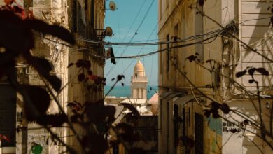 Whitewashed alleyway with blue doors in a North African medina