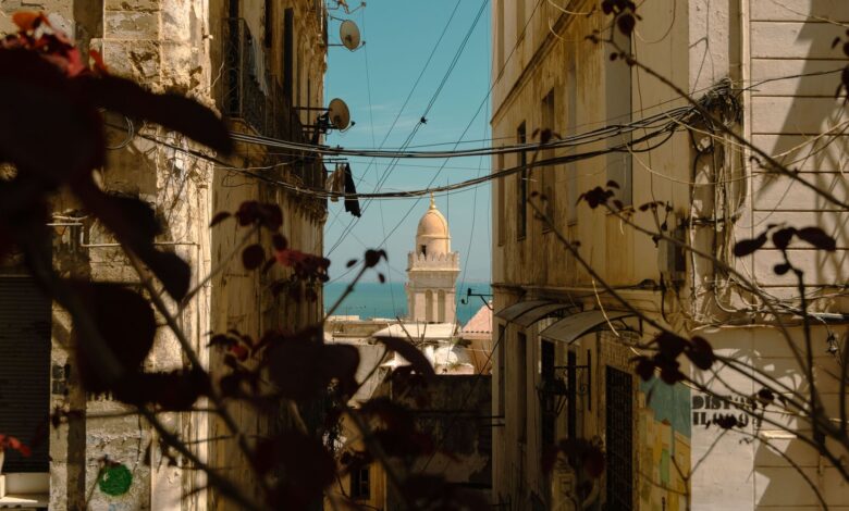 Whitewashed alleyway with blue doors in a North African medina