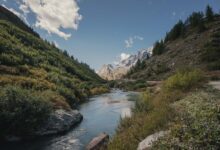 A narrow mountain valley with a river running through remote Central Asian terrain