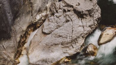 Narrow limestone canyon with a fast-flowing river cutting through tall rock walls