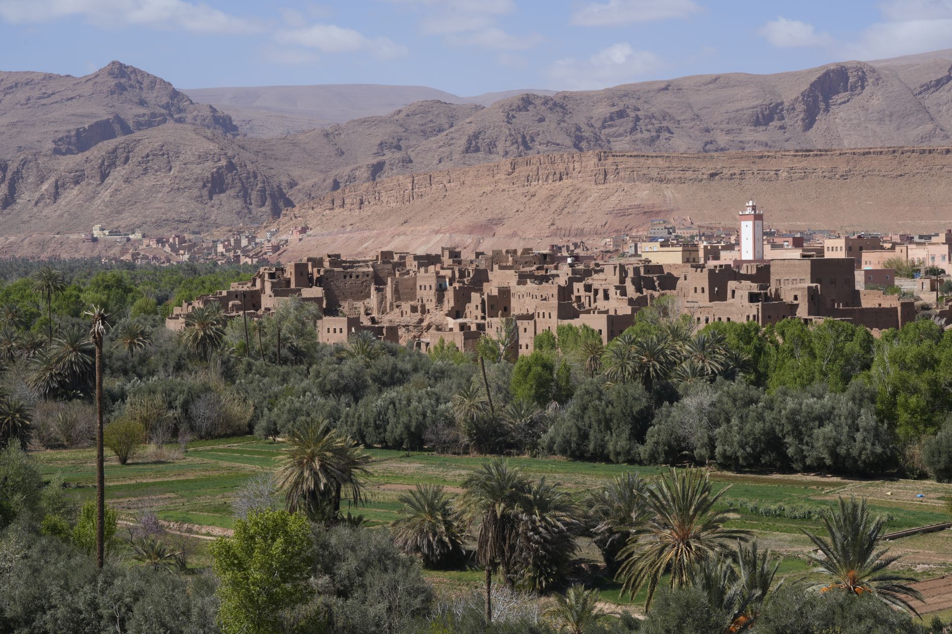 Ancient mud-brick kasbah fortress rising against a desert sky in Morocco's Draa Valley