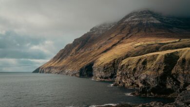 Dramatic coastal cliffs of the Faroe Islands with Atlantic Ocean below under overcast skies