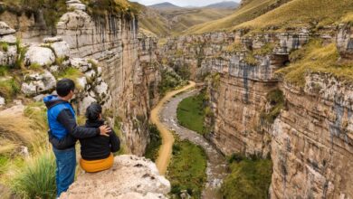 Deep canyon walls in the Peruvian Andes showing layered rock formations and terraced slopes