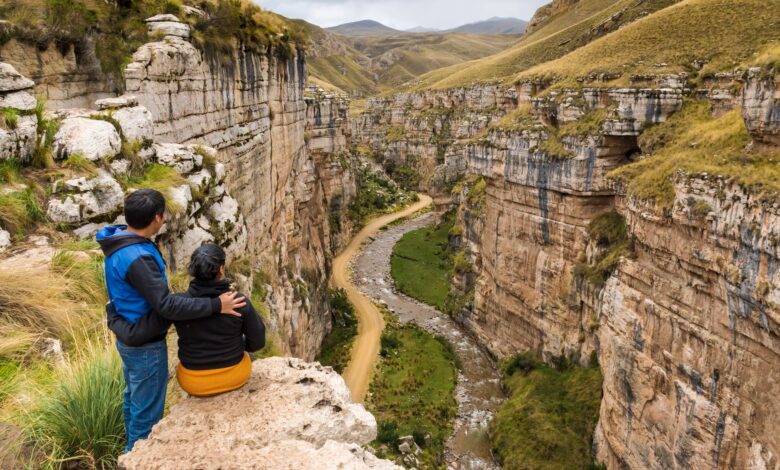 Deep canyon walls in the Peruvian Andes showing layered rock formations and terraced slopes