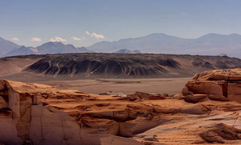 Star-filled night sky above the arid Atacama Desert landscape in Chile
