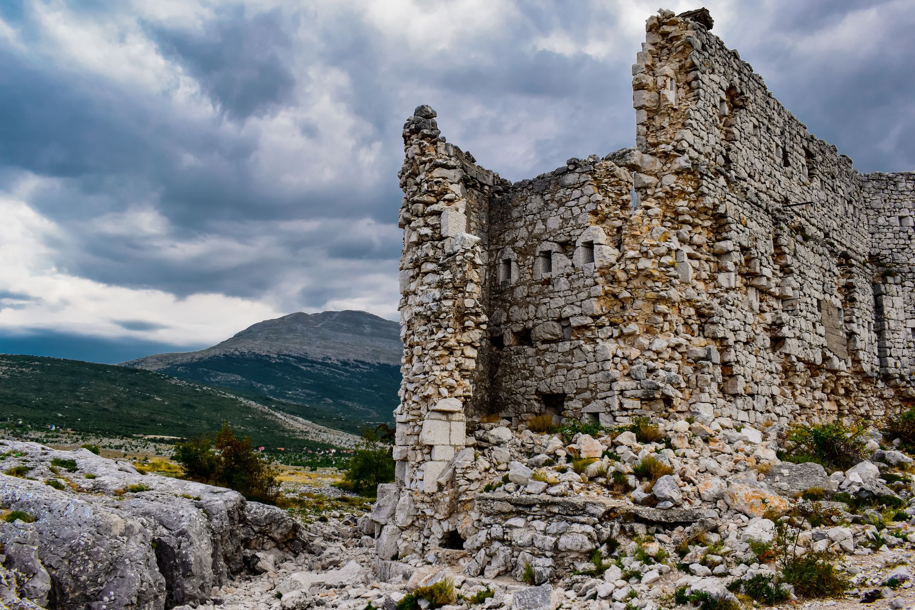 Ancient stone fortress ruins perched on a rocky mountain ridge in northern Iran