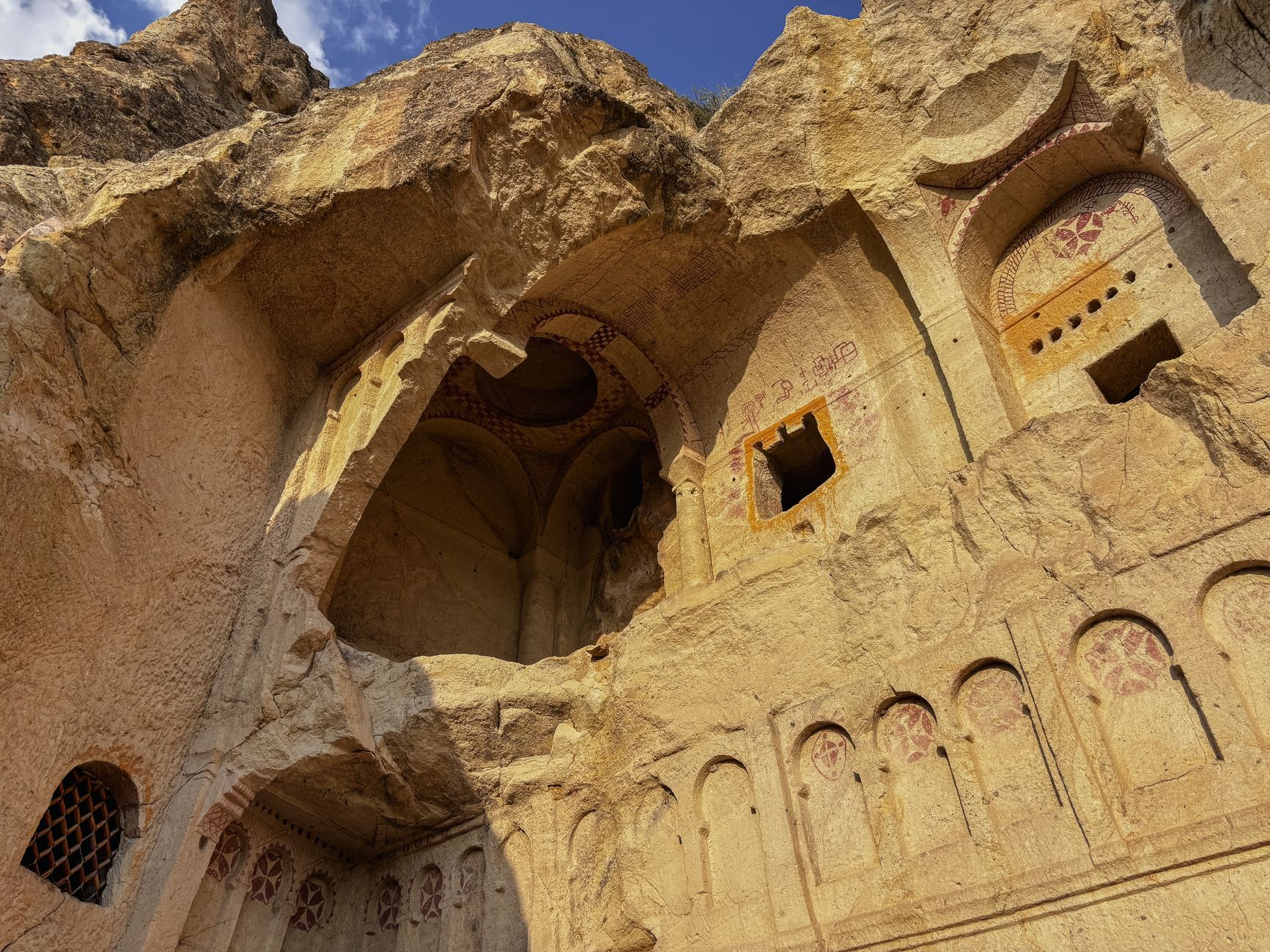 Interior of an ancient rock-carved church with stone walls and traditional religious artifacts