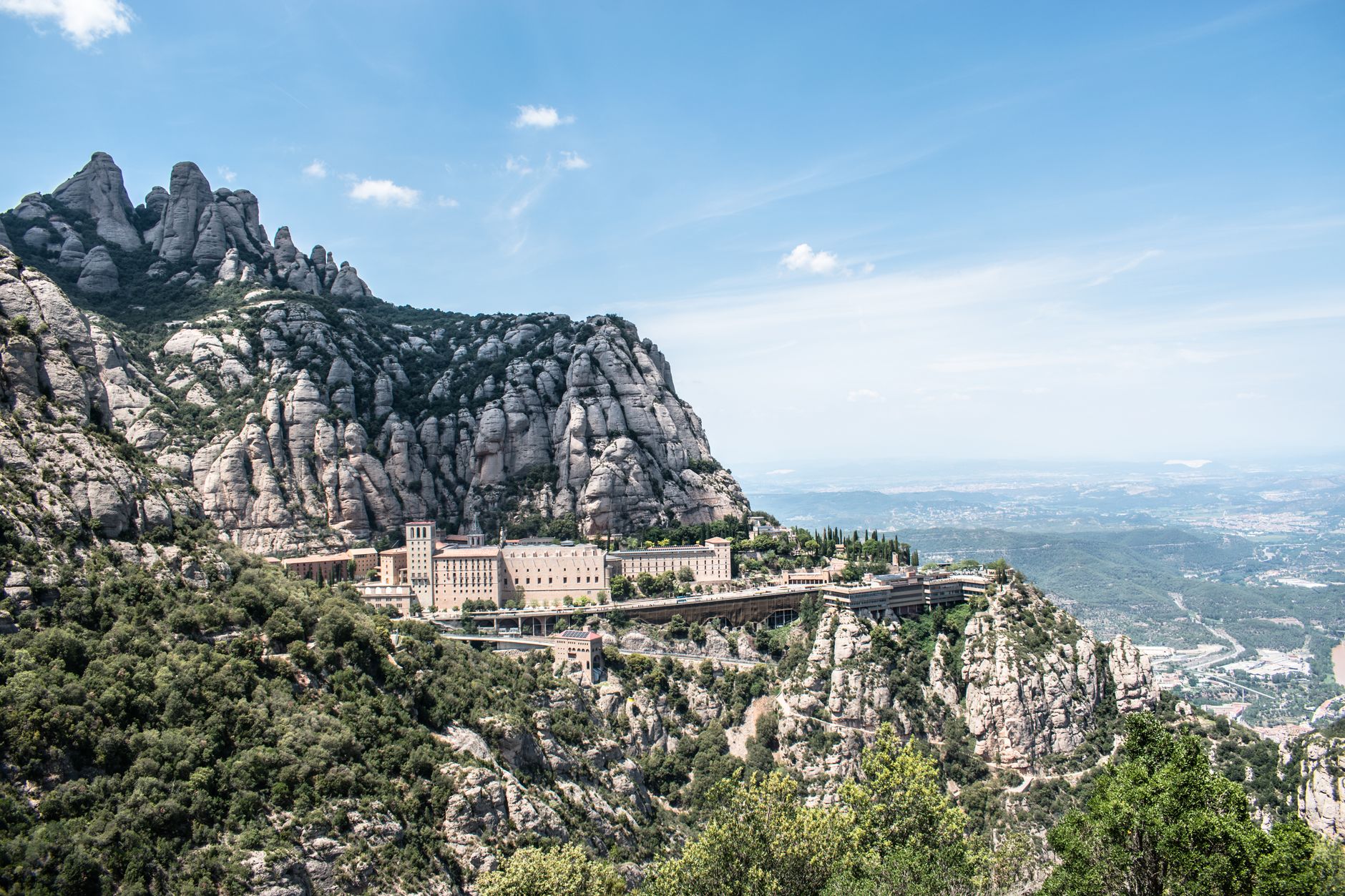 Rocky hillside with ancient carvings and pilgrims climbing stone steps