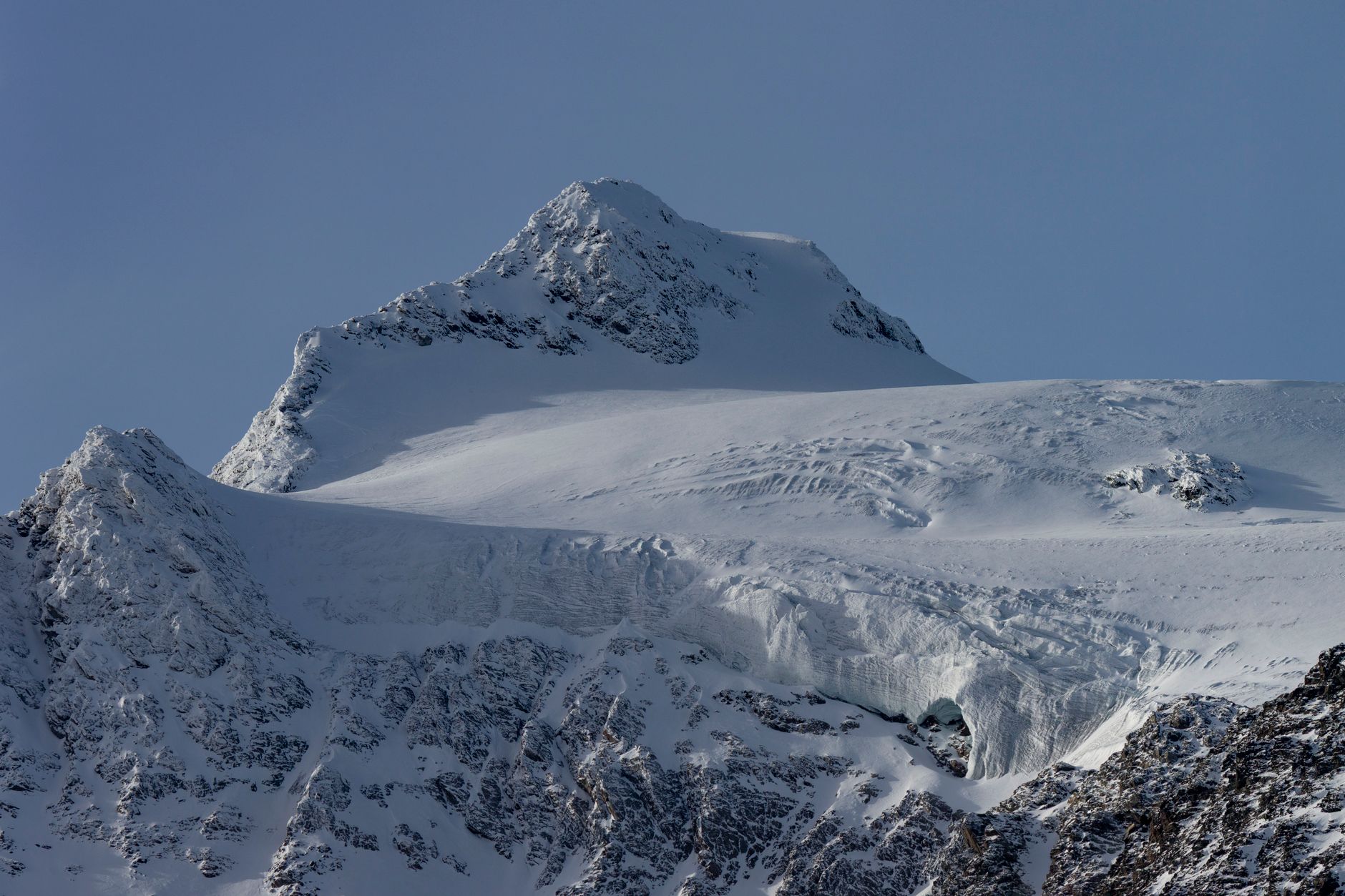 Snow and ice on the upper slopes of a high-altitude equatorial mountain at sunrise
