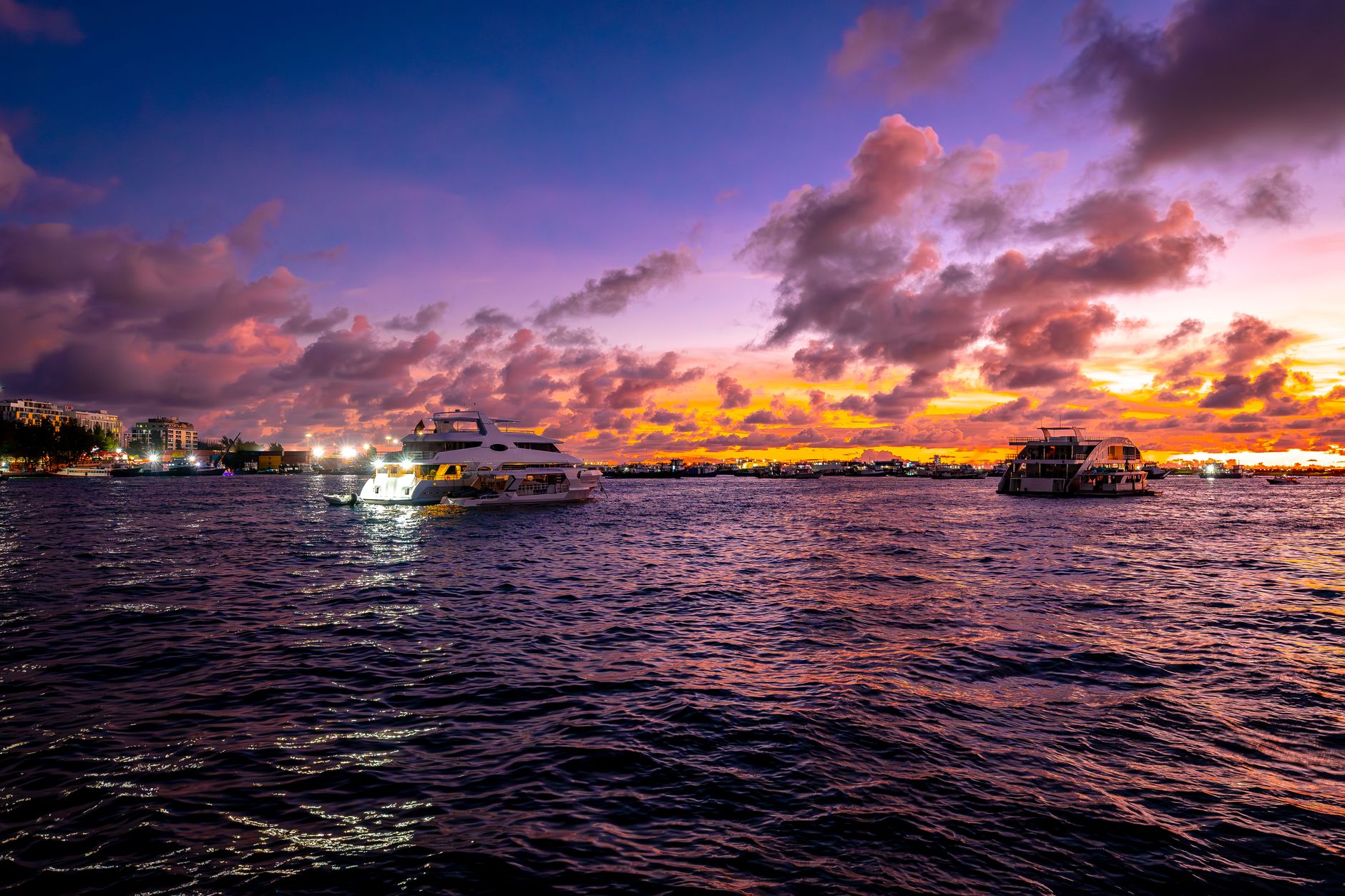 Dive liveaboard vessel anchored in calm open water at dusk