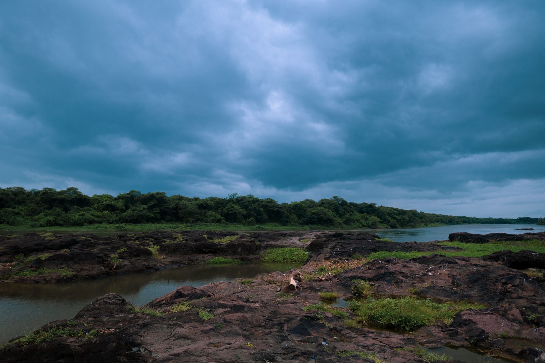Expansive African floodplain landscape with shallow water reflecting evening light