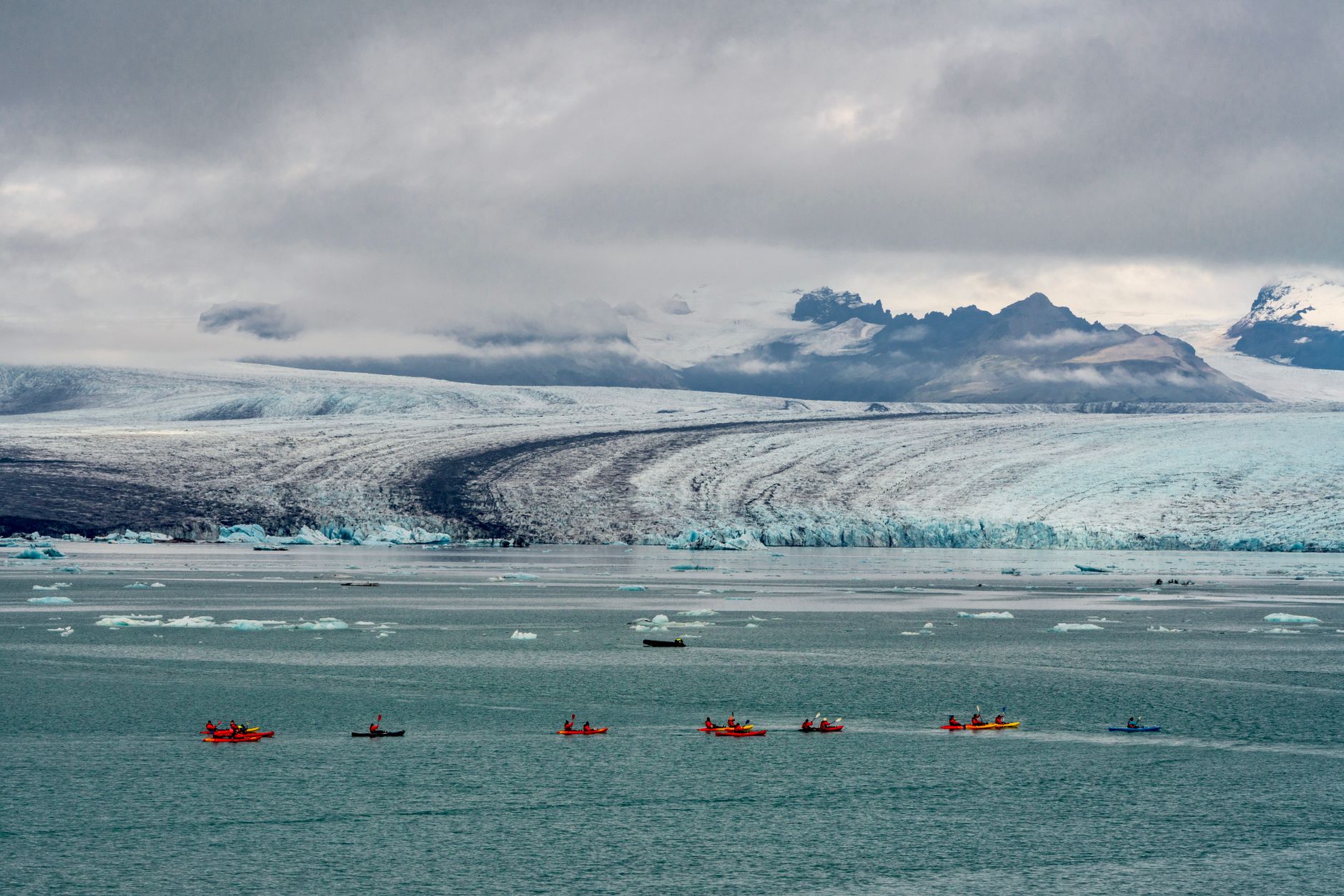 Kayaker paddling among ice formations in a remote Arctic waterway
